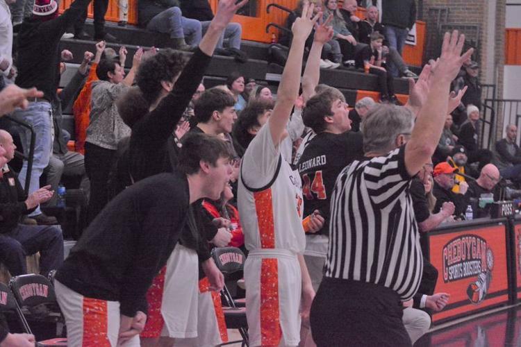 Cheboygan players celebrate from the bench after the Chiefs buried a 3-pointer during the third quarter of a district semifinal against Grayling in Cheboygan on Wednesday, Feb. 25.