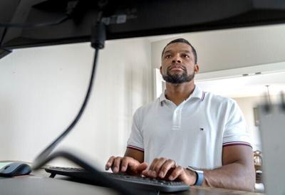 Christopher Bates works remotely in his home office Wednesday, July 2, 2025 in Westfield. He and his family recently moved to Hamilton County and used the MakeMyMove.com company that helps people with relocation. The company partners with the Indy Chamb...