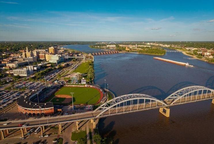 A barge travels up the Mississippi River as the Quad City River Bandits take on the Wisconsin Timber Rattlers at Modern Woodmen Park, June 16, 2026, in Davenport.