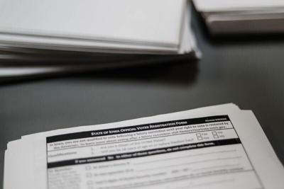 Voter registration forms sit on the front desk of the Polk County Auditor’s Office in downtown Des Moines in October 2022.
