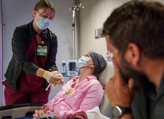 Nurse Jamie Bower prepares Victoria Means for her immunotherapy, while Victoria’s husband Ryan Means watches, at the Cass County Hospital Monday, Aug. 24, 2026 in Atlantic, Iowa. She receives this therapy roughly once per month and each time the medicat...