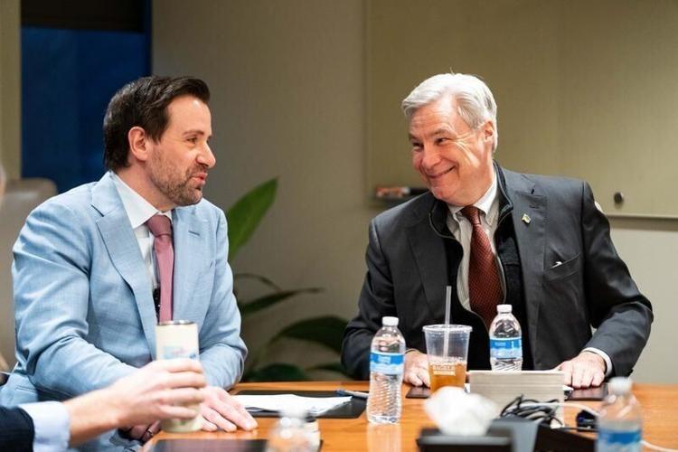 Democratic U.S. Senate candidate and Iowa State Rep. Josh Turek and U.S. Sen. Sheldon Whitehouse talk during a roundtable on extreme weather and insurance costs on April 9, 2026, in Des Moines.