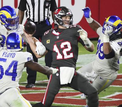 Tampa Bay Buccaneers quarterback Tom Brady (12) gets takes down as he releases the ball in the end zone for an incomplete pass bringing up a fourth and 15 in the final seconds of the third quarter of Monday Night Football at Raymond James Stadium on Mon...