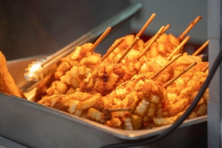 The potato half and half Korean corn dogs are seen under heat lamps during the first day of the Iowa State Fair on Aug. 7, 2025, in Des Moines.