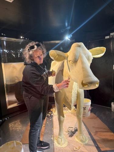 Sarah Pratt sculpting the butter cow currently featured in the "State Fairs" exhibit at the Smithsonian's Renwick Gallery.