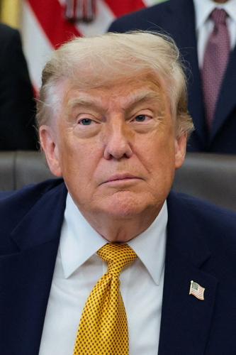 U.S. President Trump signs an executive order in the Oval Office at the White House, in Washington