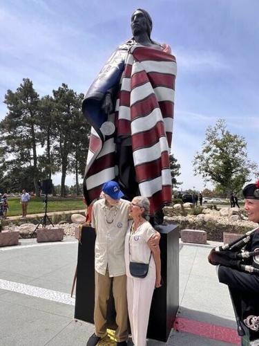 Tom Schomberg and his wife, Cynthia, stand in front of “The Gift,” a Native American veterans monument he built that now sits at Riverside National Cemetery in California.