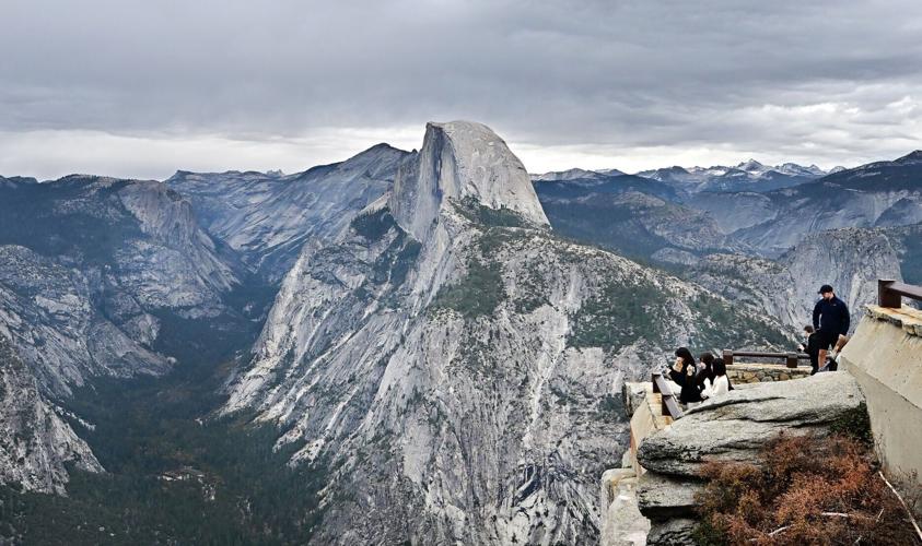 People take in the view from Glacier Point at Yosemite National Park, California on Oct. 25, 2025.