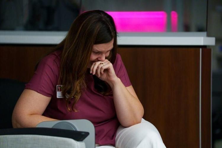 Ann McCurdy, director of marketing and communications and chair of the Cancer Action Plan Team at Cass Health, cries as she listens to one of the stories from a patient receiving treatment on Monday, Aug. 3, 2026, in Atlantic.