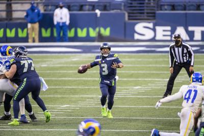 In this file photo, with protection and room to throw, Russell Wilson went 20-32, with 225 yards and a touchdown in a 20-9 win over the Rams.