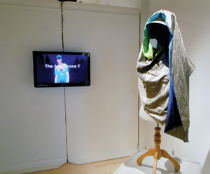 An article of Adam Harvey’s “Stealth-Wear,” and a TV screen showing someone wearing “Stealth” clothing.