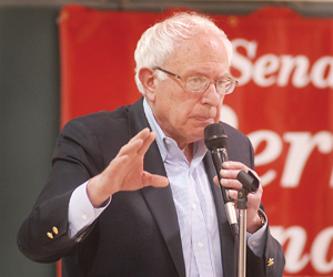 U.S. Sen. Bernie Sanders, I-Vt., talks with people at a Morristown gathering Tuesday night about the impact of federal budget cuts. 