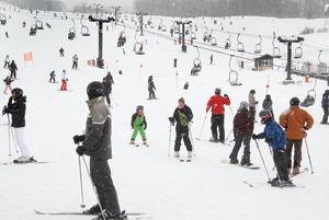 The slopes of Spruce Peak are busy from top to bottom Friday.