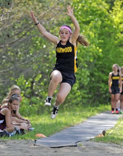Alexa Widschwenter stretches for distance in the long jump Monday in Harwood’s home track-and-field meet.