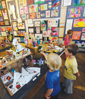 Young artists fine-tune their creations at the Thatcher Brook Primary School Art Show in Waterbury.