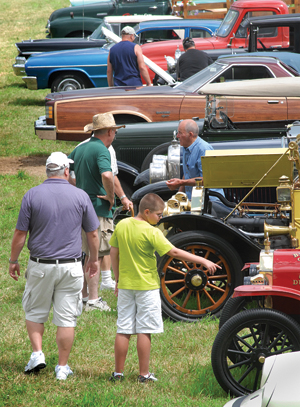 Young and old walk the rows of 700-plus vehicles at the 54th annual Stowe Antique and Classic Car Meet at Nichols Field. 