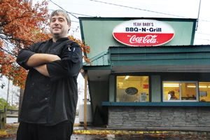 Ted Hoadley with his new barbeque establishment, Yeah Baby’s BBQ-N-Grill, in Morrisville on Tuesday.