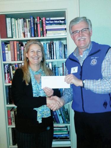 Jennifer McKay Myers, a teacher/community coordinator at Central Vermont Adult Basic Education, accepts the contribution from George Lewis on behalf of the Stowe Rotary Club.