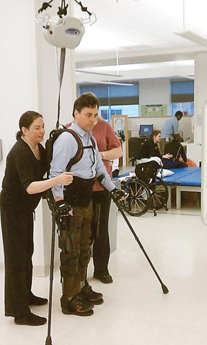 An exoskeletal suit created by Ekso Bionics enables Chris Tagatac, who is paralyzed from the waist down, to walk around.