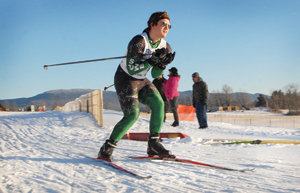 Stowe’s Max Brisben tucks around a corner at Trapps Nordic Center during a high school Nordic race on Thursday.