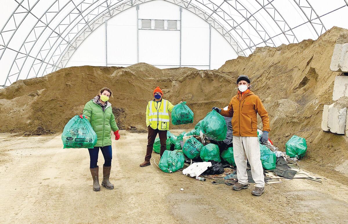 Hinesburg Conservation Commission stand with Green Up bags