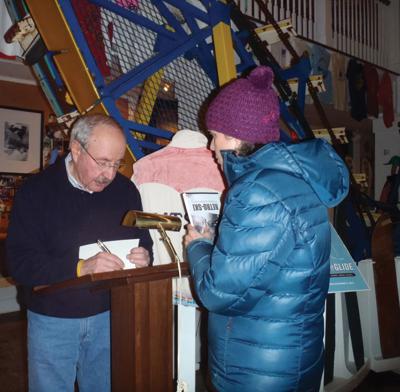 Greg Morrill signs his book at the Vermont Ski and Snowboard Museum.