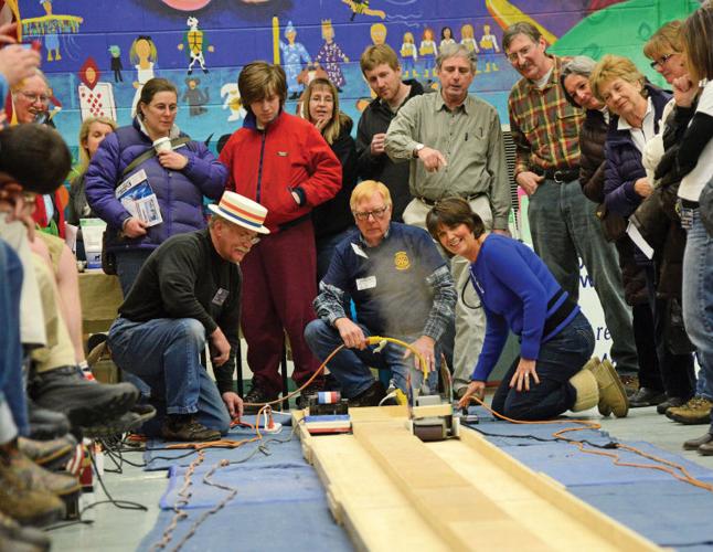 Al Lewis takes on Trish Olsen in a race down the 45-foot track Saturday as a captivated crowd looks on.