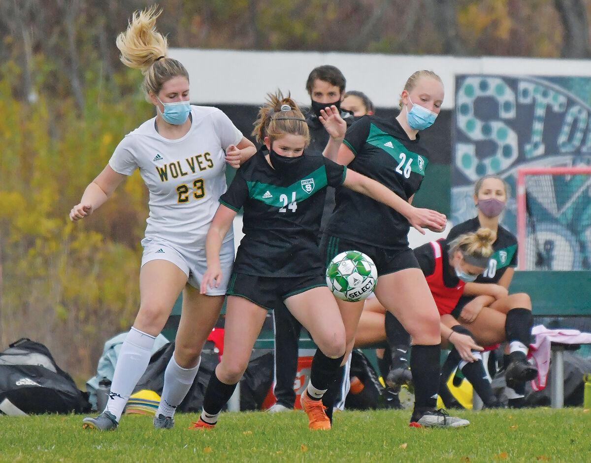 Gracie Beck battles with a pair of Stowe Raiders