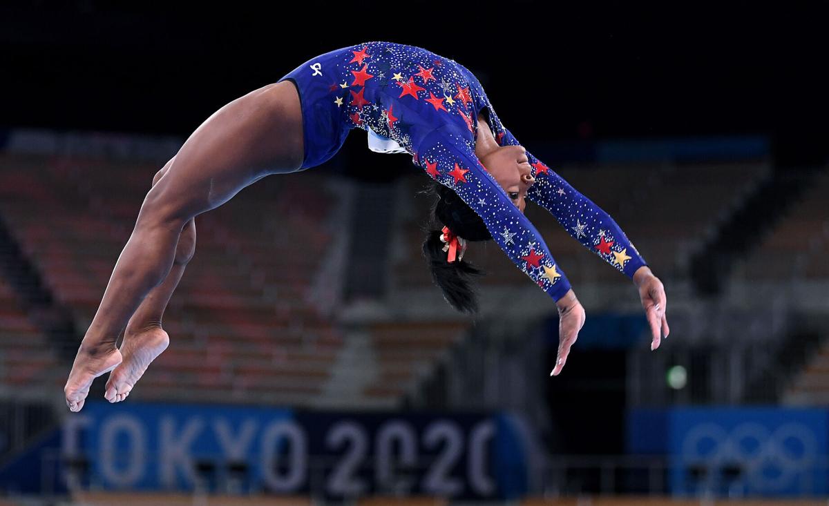 U.S. gymnast Simone Biles competes on the beam in the women's team qualifying at the 2020 Tokyo Olympics on Sunday, July 25, 2021.