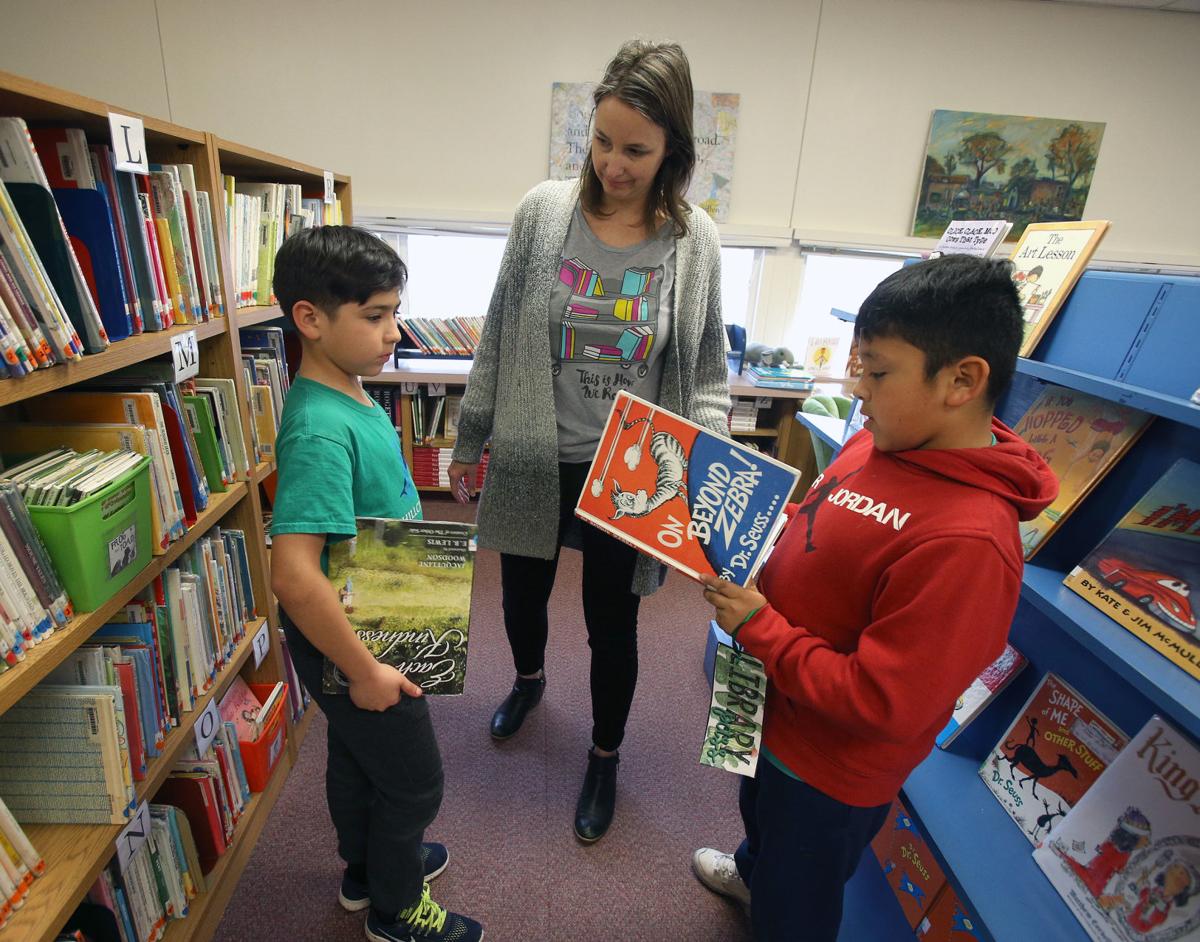 Schools cite budget cuts as reason for having more aides than librarians Education
