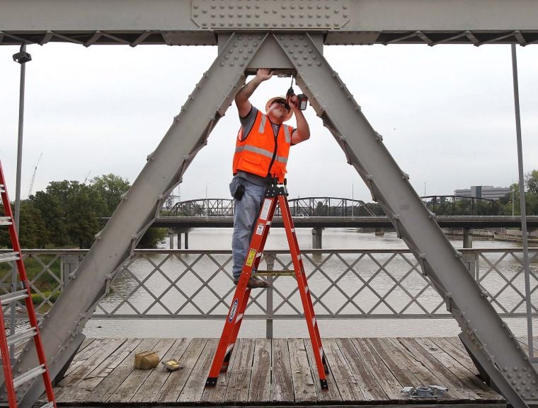 Workers begin turning up the lights on Waco’s Suspension Bridge