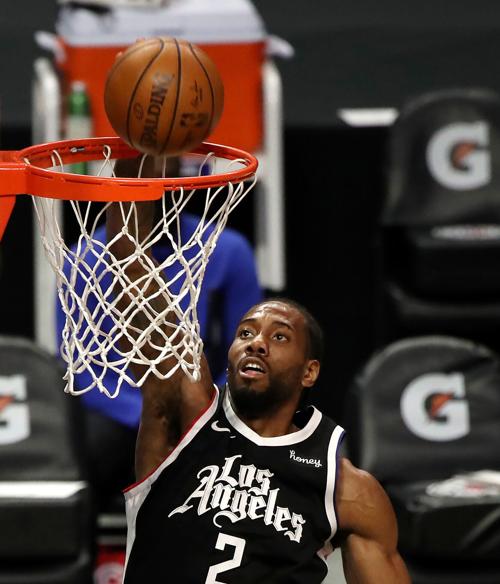Kawhi Leonard of the Los Angeles Clippers dunks against the Houston Rockets during the second quarter at Staples Center on Friday, April 9, 2021, in Los Angeles.