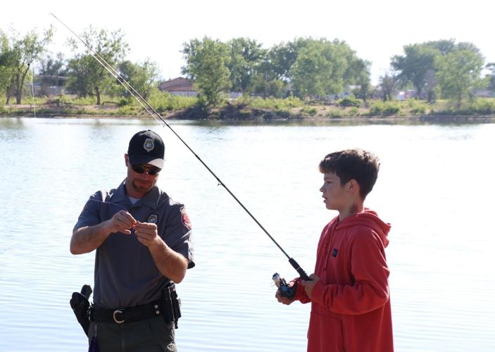 Officers and residents bond over fishing at first Cops and Bobbers event