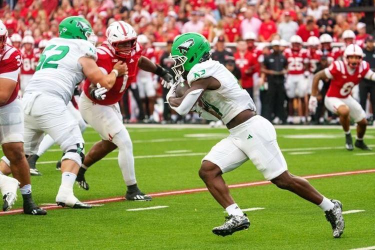 Sep 19, 2026; Lincoln, Nebraska, USA;  North Dakota Fighting Hawks running back Matt Lawson (4) runs against the Nebraska Cornhuskers during the first quarter at Memorial Stadium.  Mandatory Credit: Dylan Widger-Imagn Images