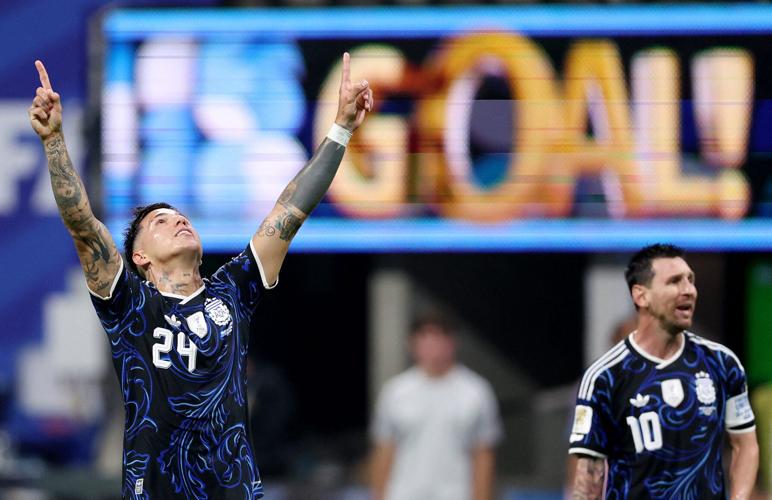 Argentina's Enzo Fernandez celebrates scoring their first goal with Lionel Messi.