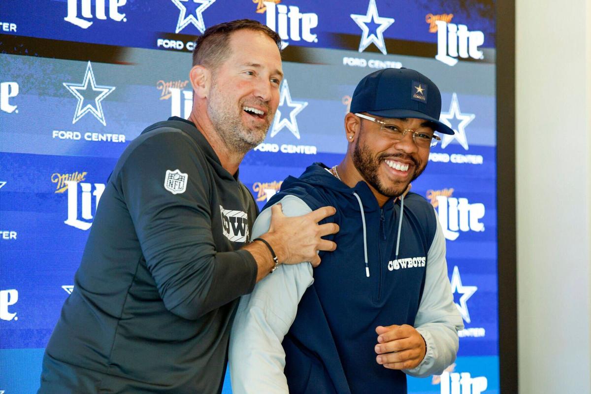 Dallas Cowboys head coach Brian Schottenheimer, left, jokingly shakes new defensive coordinator Christian Parker after an introductory news conference at The Star, Wednesday, Feb. 18, 2026, in Frisco, Texas.