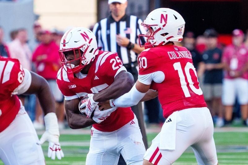 Sep 12, 2026; Lincoln, Nebraska, USA;  Nebraska Cornhuskers quarterback Anthony Colandrea (10) hands the ball off to running back Jamal Rule (25) against the Bowling Green Falcons during the first quarter at Memorial Stadium.  Mandatory Credit: Dylan Wi...
