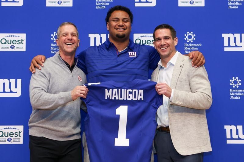 New York Giants draft pick Francis Mauigoa, coach John Harbaugh (left) and general manager Joe Schoen (right) pose for a photo during an introductory press conference April 24 at Quest Diagnostics Training Center in East Rutherford, NJ.