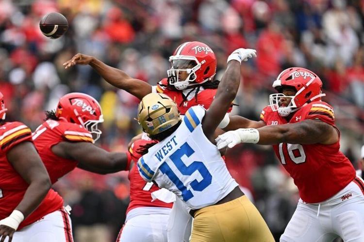 Sep 26, 2026; College Park, Maryland, USA;  Maryland Terrapins quarterback Malik Washington (7) passes in the first half against the UCLA Bruins at SECU Stadium. Mandatory Credit: Jamie Sabau-Imagn Images