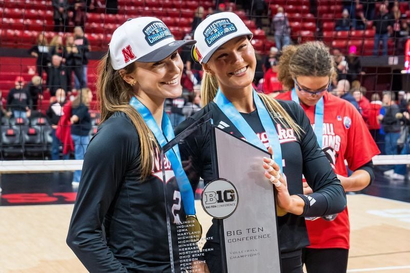 Nov 28, 2025; Lincoln, Neb, USA; Nebraska Cornhuskers setter Bergen Reilly (2) and middle blocker Andi Jackson (15) pose with the 2025 Big Ten Volleyball Champions trophy after the match against the Penn State Nittany Lions at Bob Devaney Sports Center....