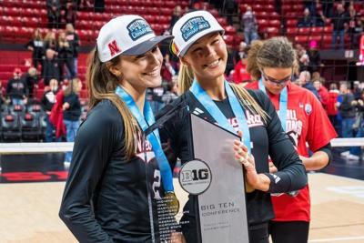 Nov 28, 2025; Lincoln, Neb, USA; Nebraska Cornhuskers setter Bergen Reilly (2) and middle blocker Andi Jackson (15) pose with the 2025 Big Ten Volleyball Champions trophy after the match against the Penn State Nittany Lions at Bob Devaney Sports Center....