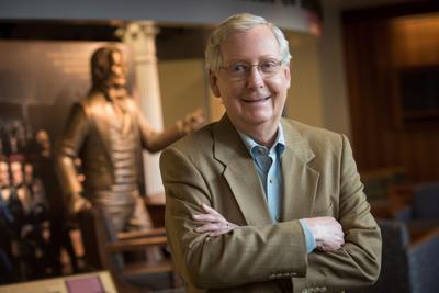 U.S. Sen. Mitch McConnell, R-Kentucky, poses near the stature of Henry Clay at the McConnell-Chao Archives at the University of