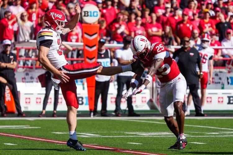 Oct 3, 2026; Lincoln, Nebraska, USA;  Nebraska Cornhuskers defensive back Jeremiah Charles (25) runs into Maryland Terrapins punter Bryce McFerson (34) during the first quarter at Memorial Stadium.  Mandatory Credit: Dylan Widger-Imagn Images