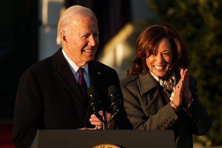 President Joe Biden speaks as Vice President Kamala Harris cheers for him during a ceremony at the White House in 2022.