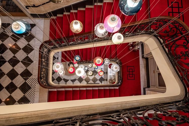 Checkerboard floors to red velvet, rising into quiet elegance at Villas Foch. (Benjamin Myers/TNS
