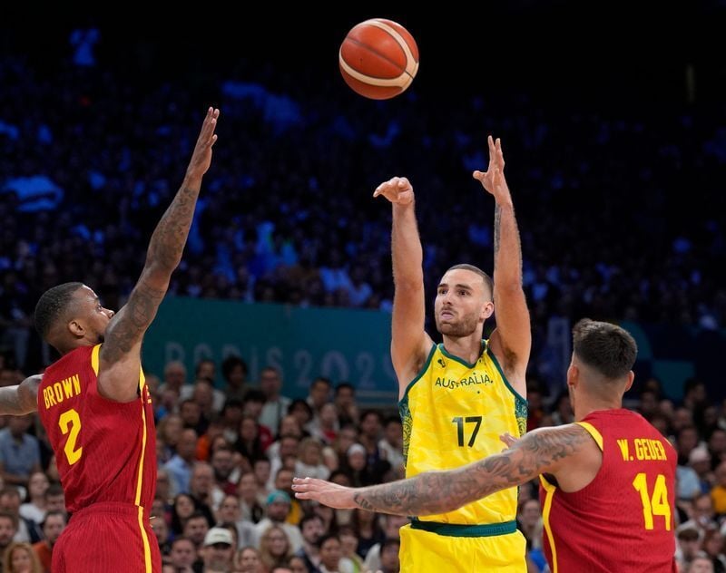 Jul 27, 2024; Villeneuve-d'Ascq, France;  Australia small forward Jack McVeigh (17) shoots over Spain guard Lorenzo Brown (2) and Spain centre Willy Hernangomez (14) in men's Group A play during the Paris 2024 Olympic Summer Games at Stade Pierre-Mauroy...