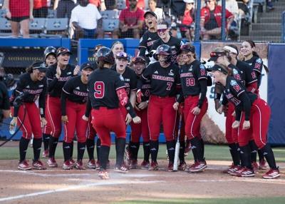 May 30, 2026; Oklahoma City, OK, USA; Nebraska Cornhuskers players wait at home plate for utility Hannah Camenzind (9) after she hit a solo home run in the fourth inning against the Alabama Crimson Tide during the NCAA WomenÕs College World Series at De...