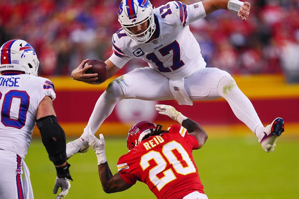 Josh Allen of the Buffalo Bills hurdles over Justin Reid of the Kansas City Chiefs, during the fourth quarter at Arrowhead Stadium on Oct. 16, 2022, in Kansas City, Mo..