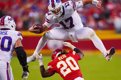Josh Allen of the Buffalo Bills hurdles over Justin Reid of the Kansas City Chiefs, during the fourth quarter at Arrowhead Stadium on Oct. 16, 2022, in Kansas City, Mo..