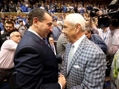 Duke head coach Mike Krzyzewski, left, talks to North Carolina head coach Roy Williams before a 2018 game at Cameron Indoor Stadium in Durham, North Carolina.